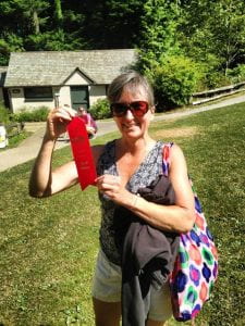 Donna Janigo celebrates a 2nd place finish in her division at the Chuckanut Footrace by holding up her award