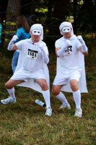 two men in full white outfit with mask and cape at the Muds to Suds run