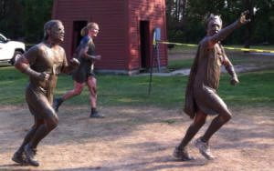 two participants covered in mud at the Muds-to-Suds race