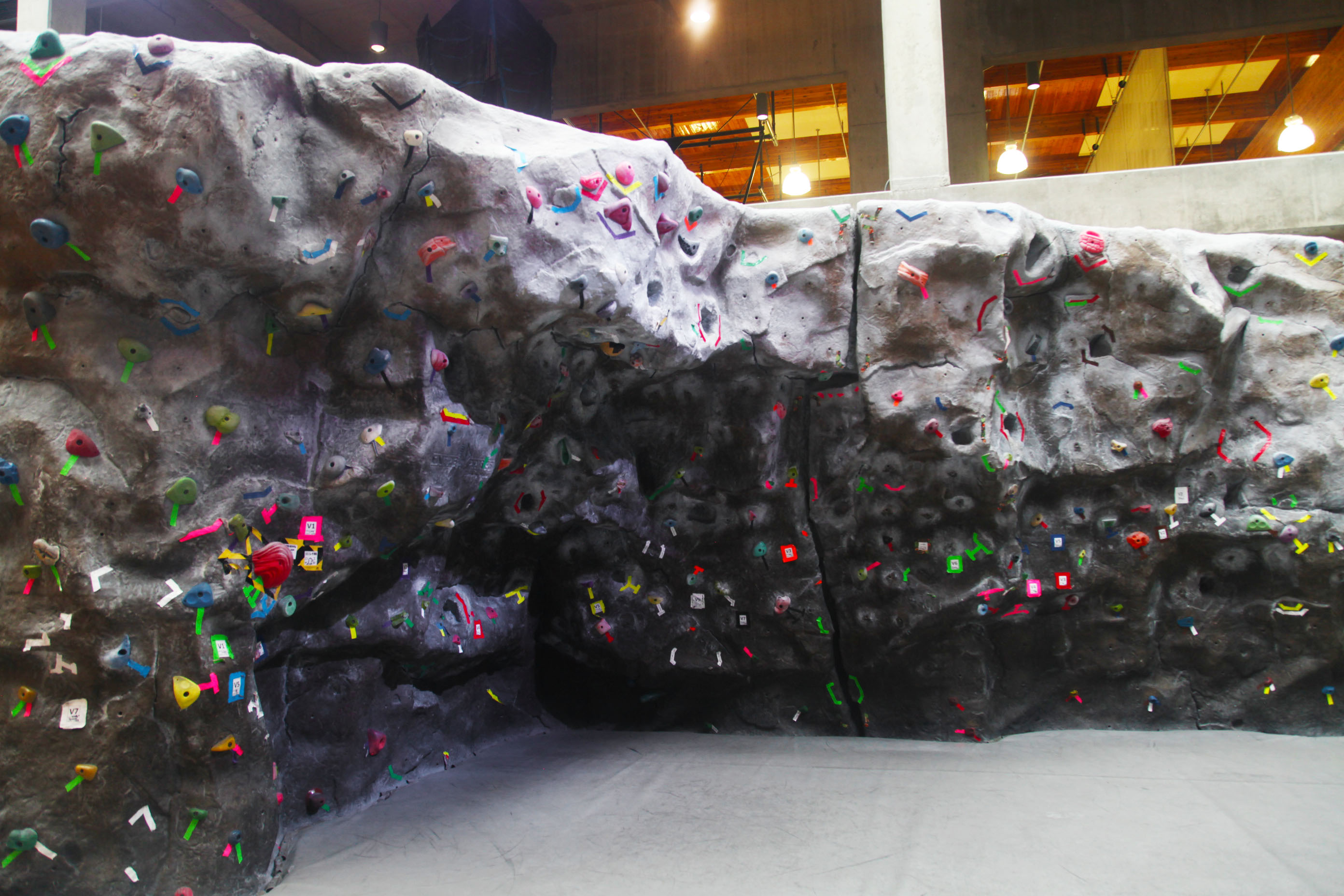 WWU's colorful rock climbing wall with various rocks of different sizes and shapes.