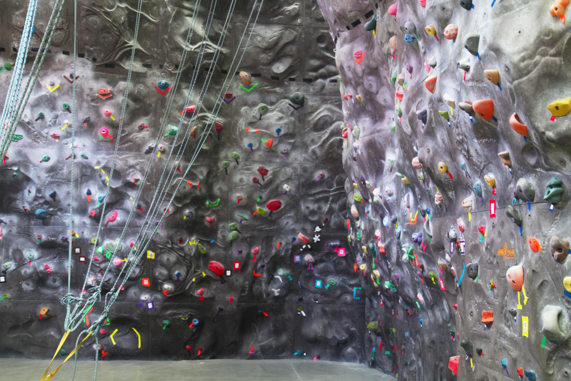 WWU climbing wall with colorful climbing tape and climbing holds