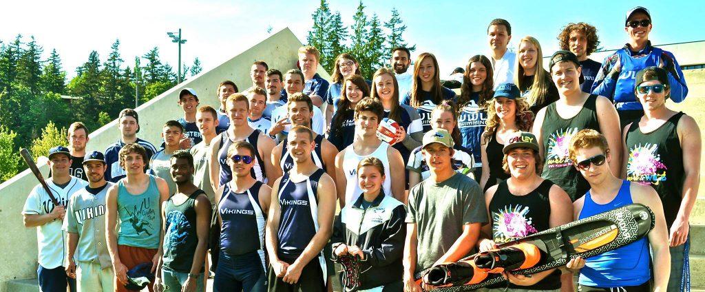 large group of athletes who participate in WWU sport clubs, all wearing their various uniforms