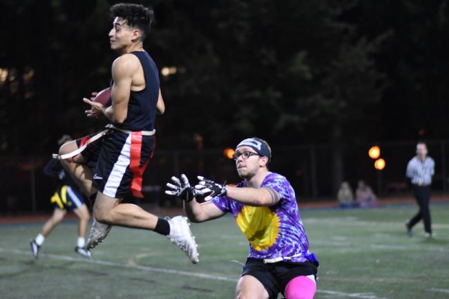 flag football player catching the ball mid-air on the WWU track field