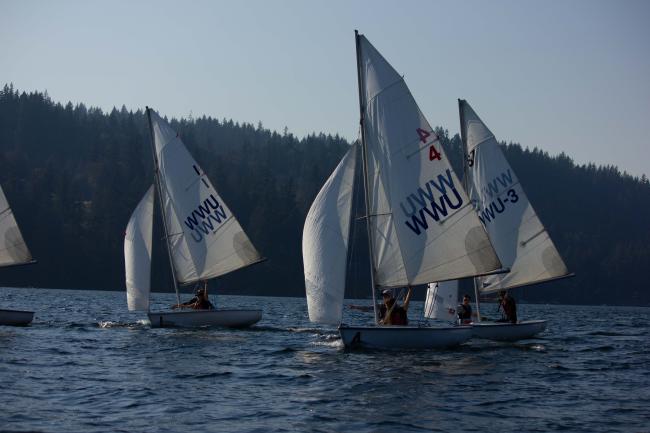 WWU Sailing Team on the water in 3 sailboats with white sails