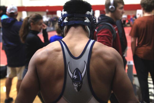 wrestler standing with back to camera in singlet