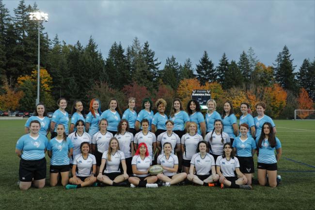 women's rugby team in blue and white jerseys on Harrington field